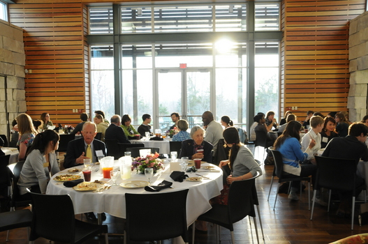 Participants in the Undergraduate Ethics Symposium eating dinner in the Great Room