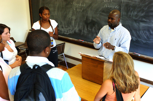 Professor Matthew Oware meets with students after class.