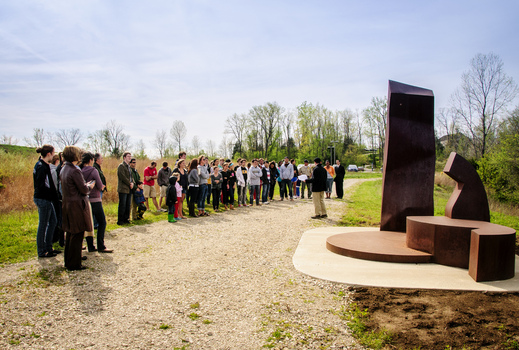 Professor Michael Mackenzie presents during the re-dedication of Mark Warwick's sculpture "Reach"