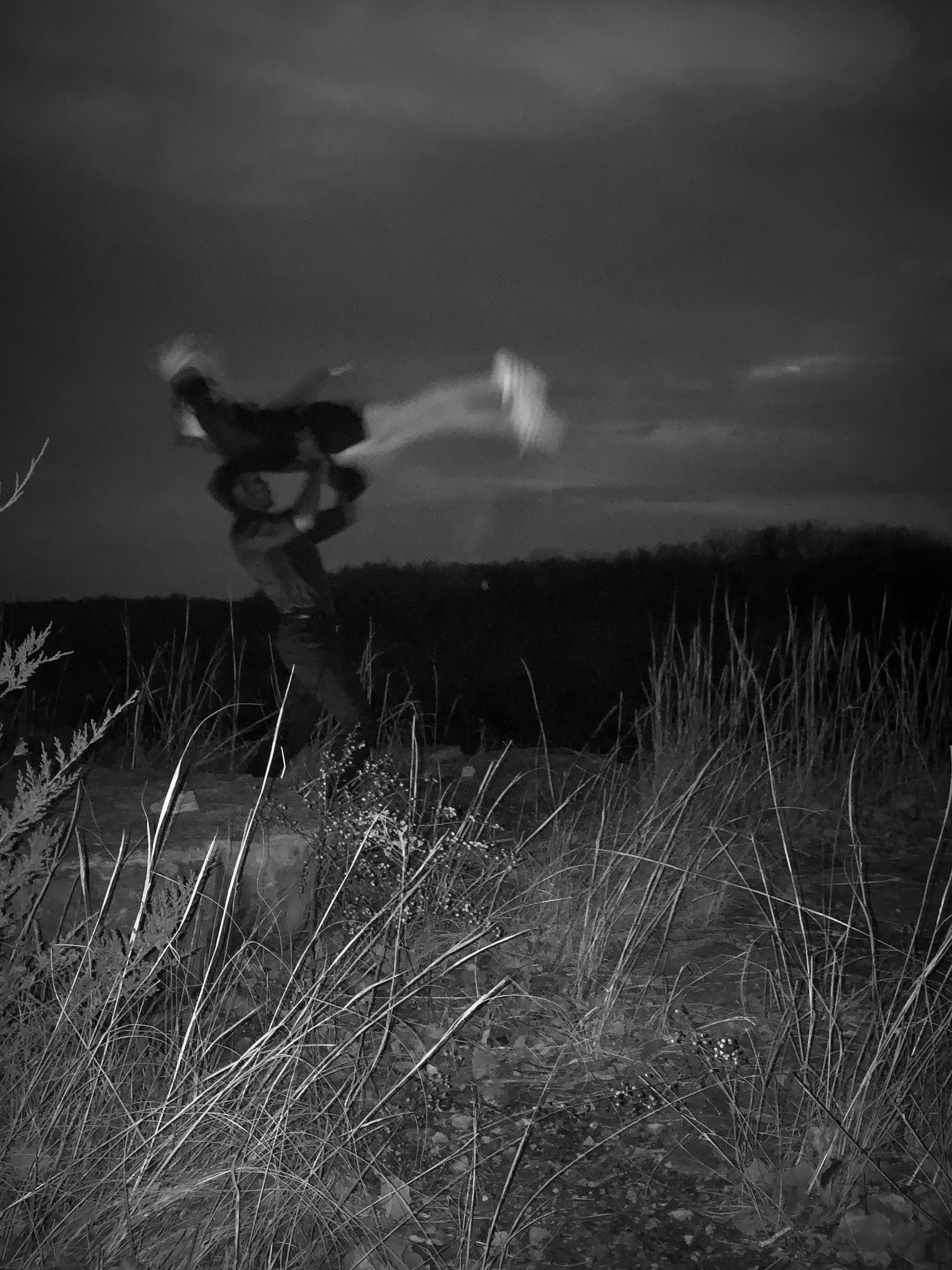 Black and white photo of a man lifting a woman in the air