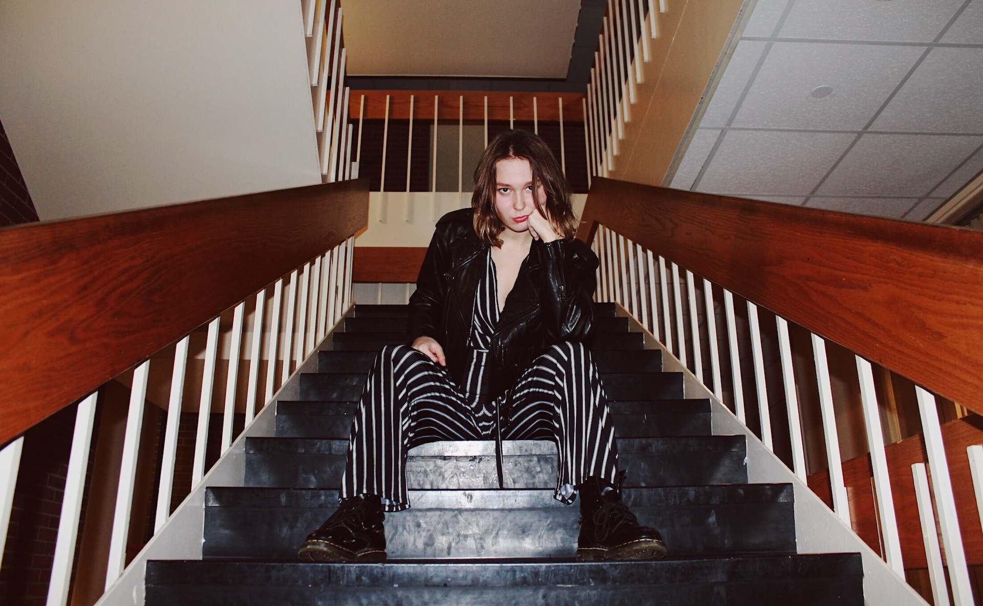 Woman seated on stair case