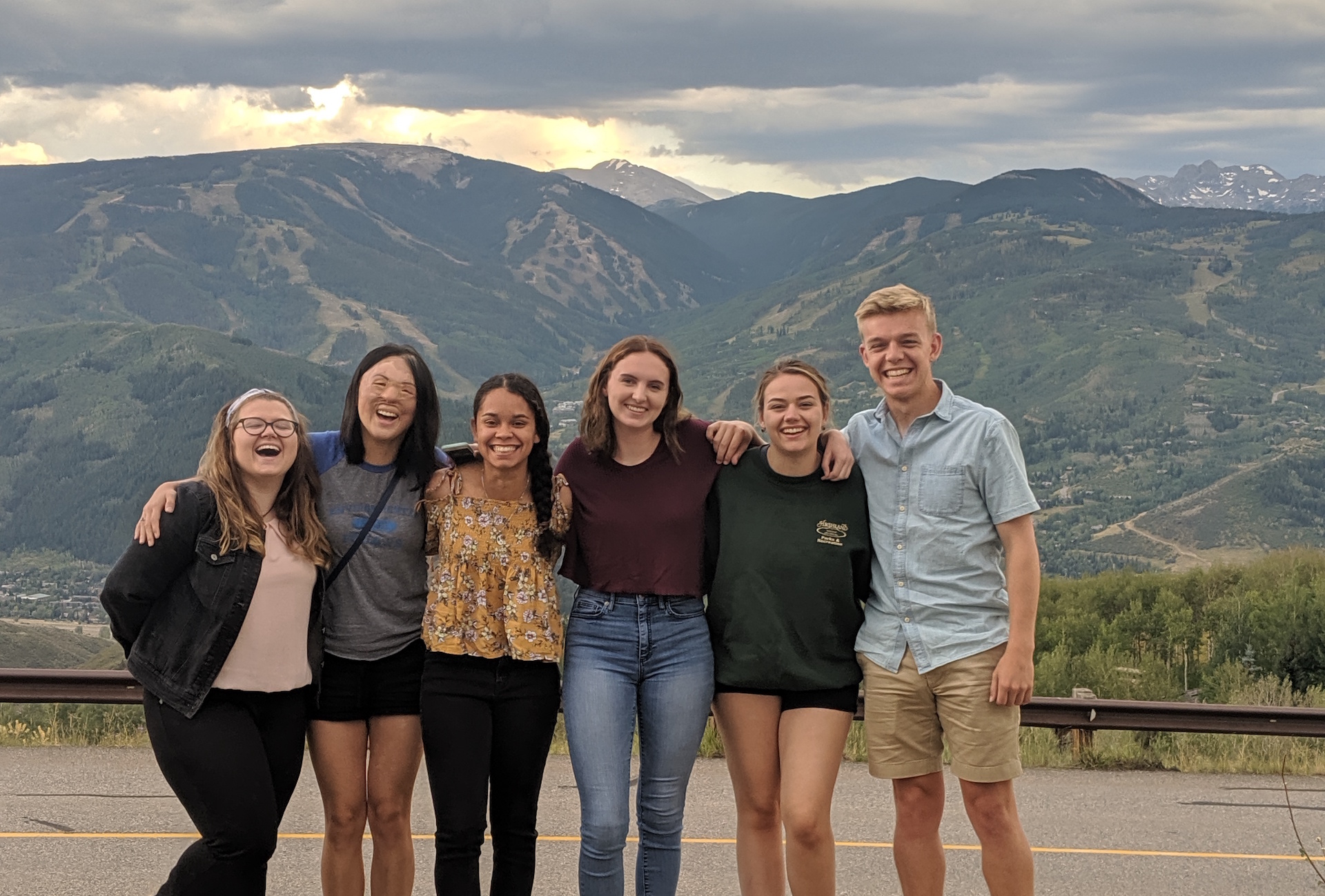 students standing in a group in front of mountains