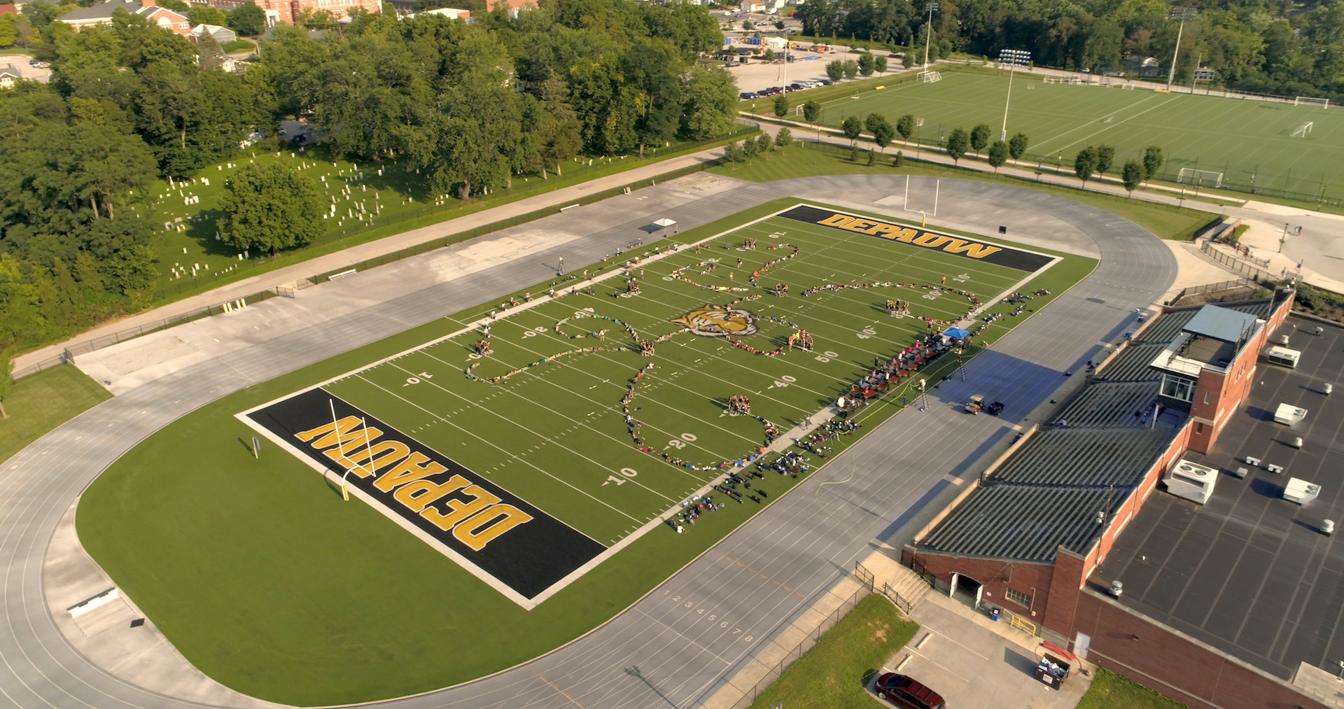 drone view of band camp practicing on Nick Mourouzis Field