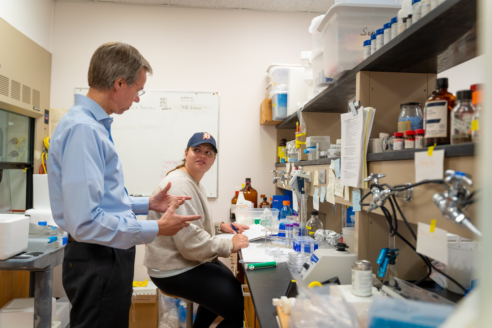 Professor and student talking to each other in a lab