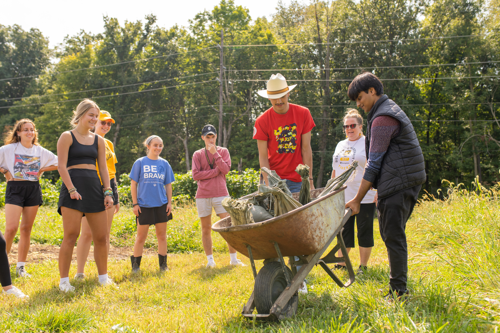 students pushing wheelbarrow