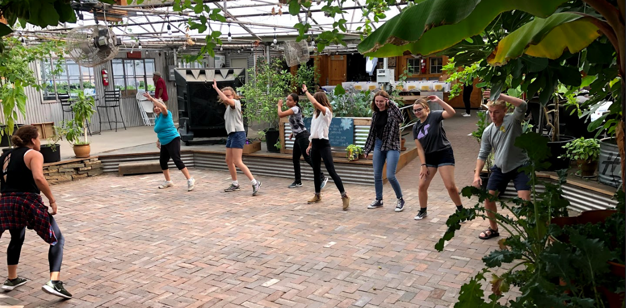 students doing zumba in a courtyard 