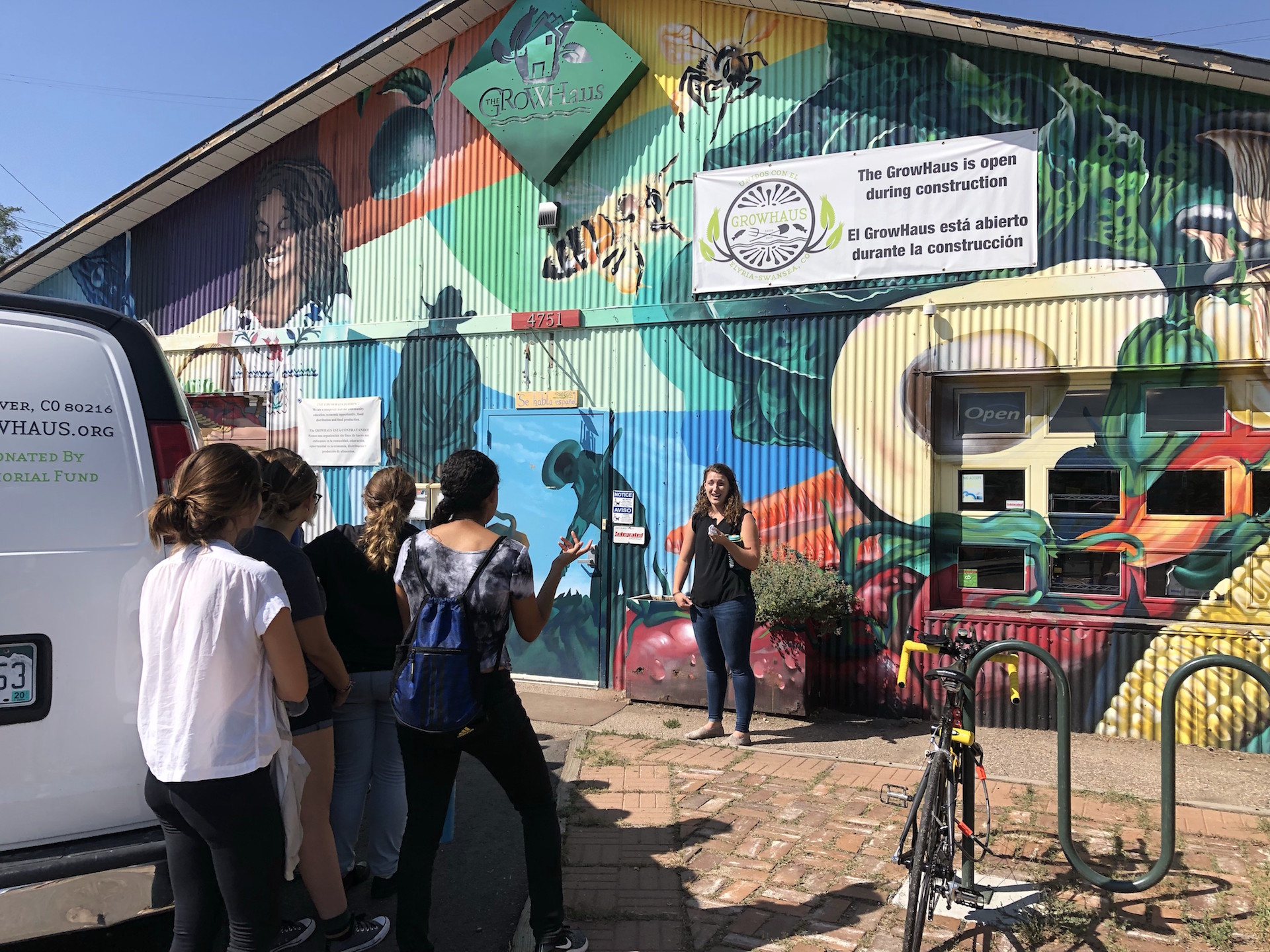 person talking next to painted building