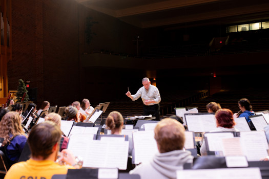 Prof. Pare conducting the University Band for the Holiday Gala rehearsal