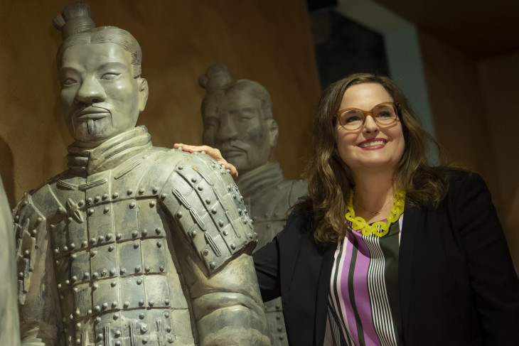 Jennifer Pace Robinson stands with Chinese warrior statues.