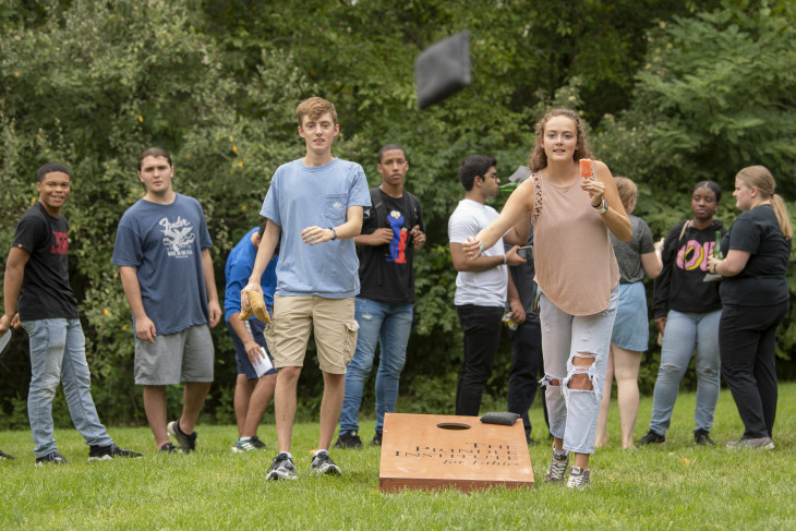 Students playing corn hole