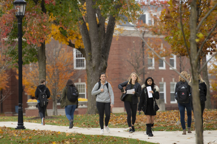 Students walk on campus on a fall day