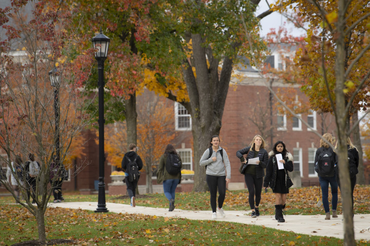 students walking to campus on a fall day