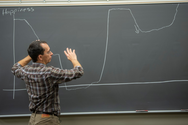 Professor Jacob Hale stands at a chalkboard 