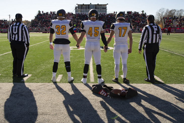 DePauw Football players on the sidelines ahead of the coin flip