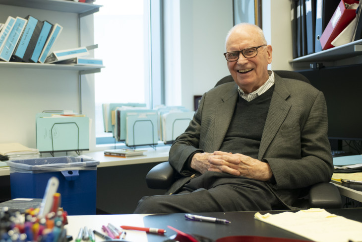 Lee Hamilton sits behind desk