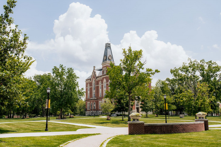 East College with fluffy clouds behind it