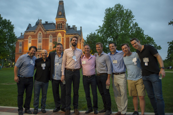 Alumni standing in east college lawn 