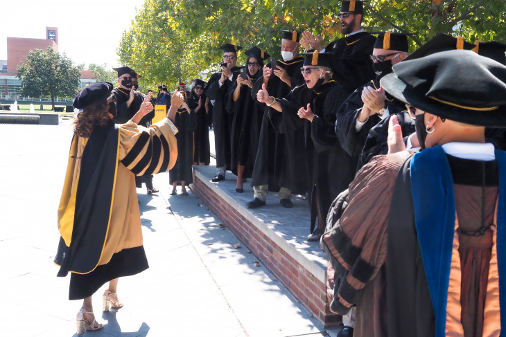 Faculty members give Dr. White a thumbs up.