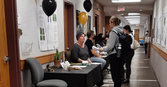 Students engaging with bio fair presenters