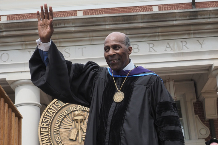 Vernon Jordan waves to the commencement crowd