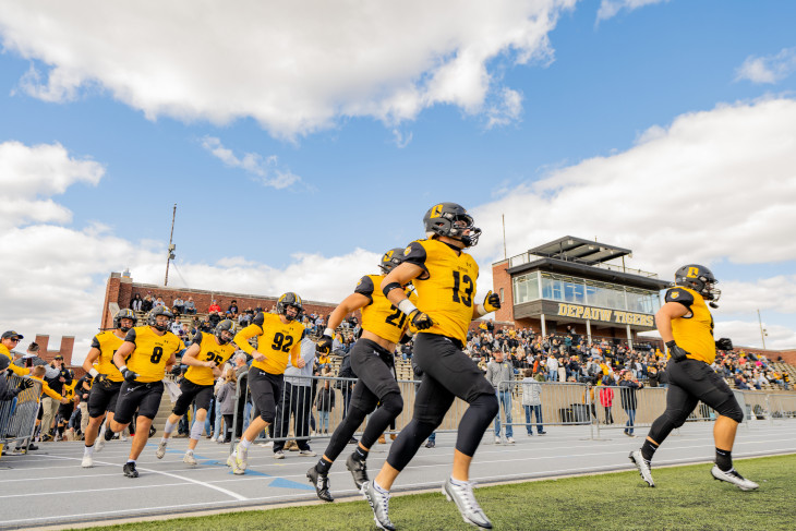 DePauw football team warming up on the football field