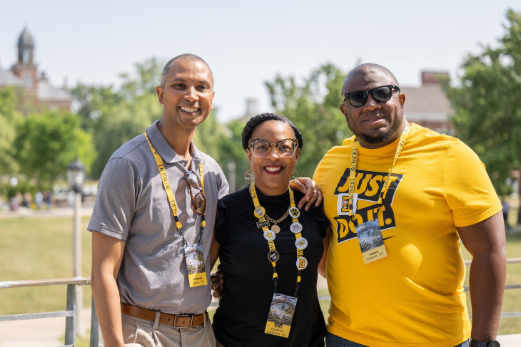 Alumni smiling together on campus