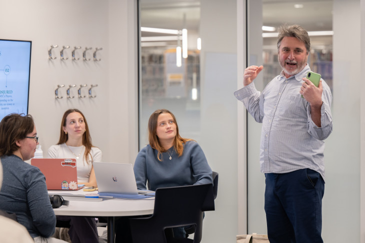 Harry Brown talks with students in classroom