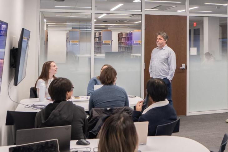 Harry Brown talks with students during class