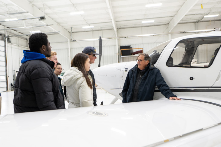 Gary Lemon shows students around an airplane
