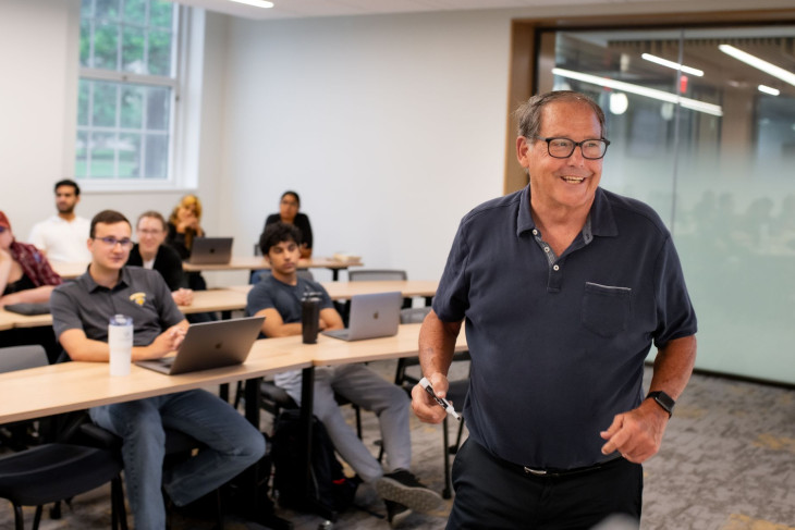 Gary Lemon smiles at the front of the classroom