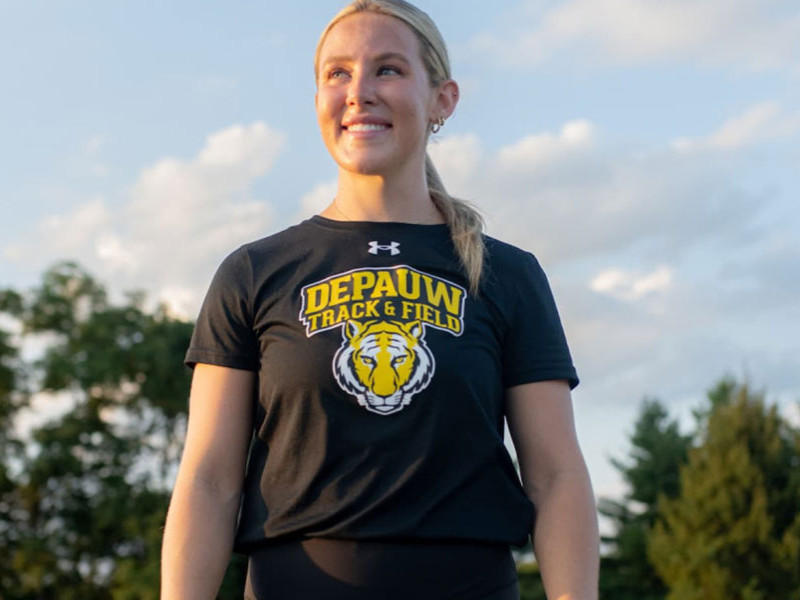 female standing in front of track 
