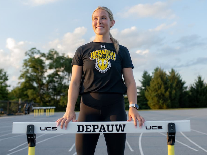 female standing in front of track 