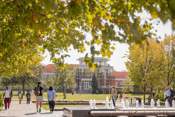 Students walking on a sunny day on campus