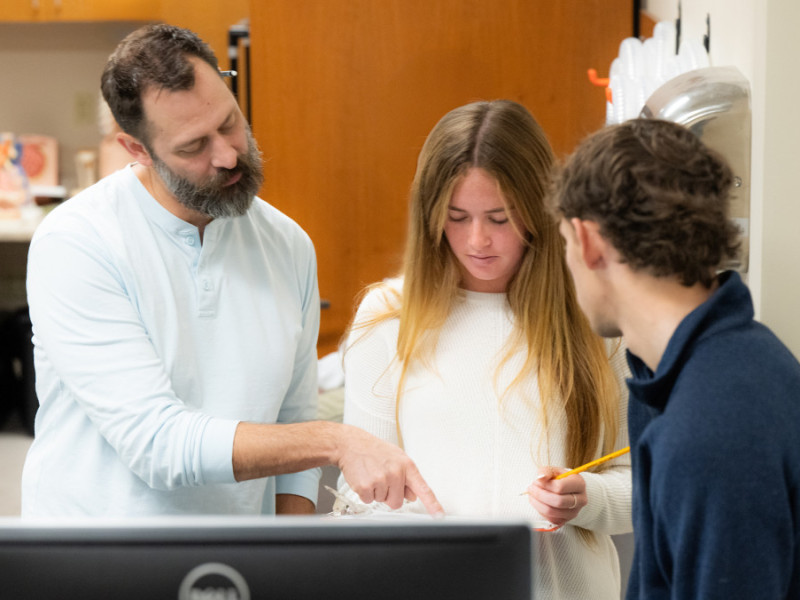 Brian Wright analyzes data in the lab with students