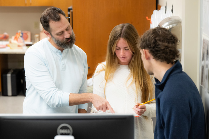 Brian Wright analyzes data in the lab with students