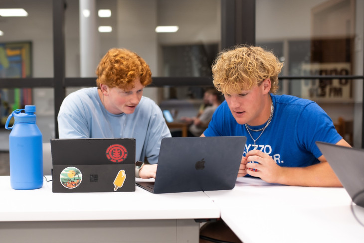 Students work together on computers