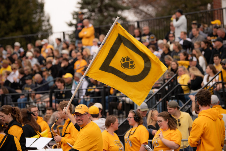 DePauw flag in front of the Monon Bell crowd