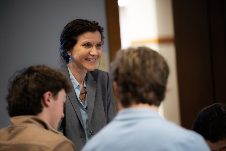 Francesca Seaman talks with students during class