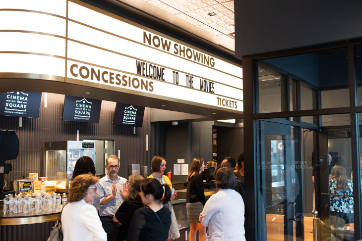 People gather in the lobby of the cinema