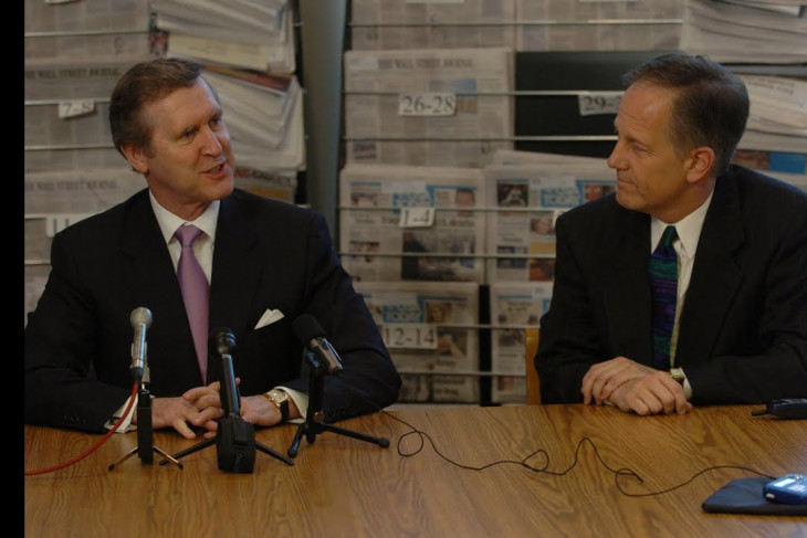 William S. Cohen sitting with Ken Owen during a press conference