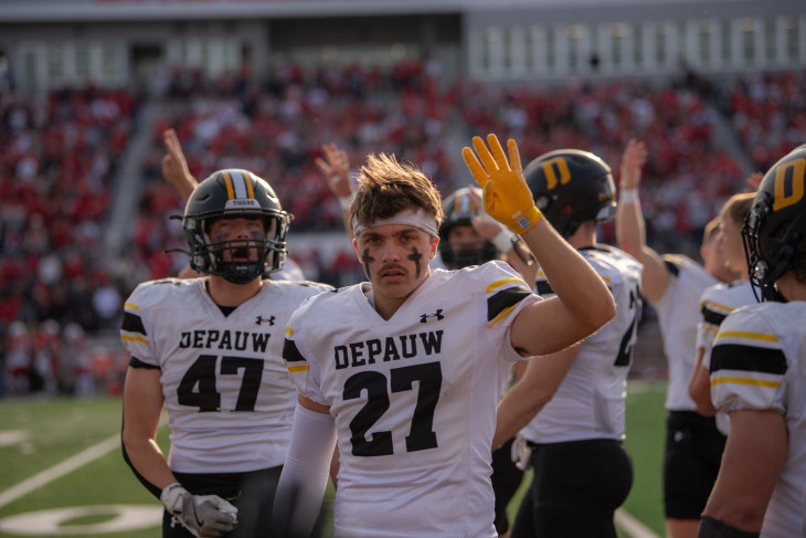 DePauw Football players hold up four fingers during Monon Bell game
