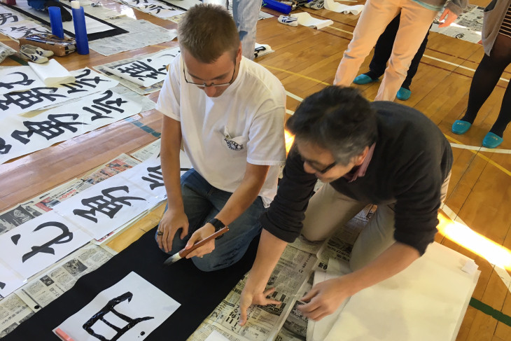 a student practicing Japanese calligraphy