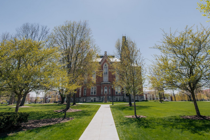 Spring campus shot - trees with building in the background