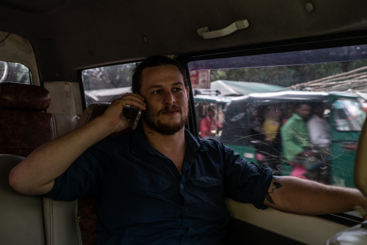 Ben Solomon on the phone in a car in Rohingya