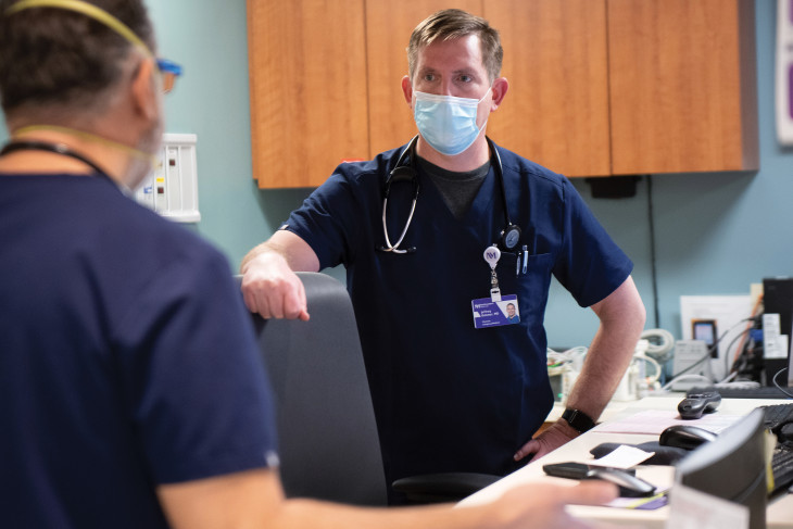 Jeff Bohmer ’95 in blue scrubs wearing a medical mask