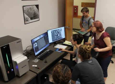 Students hovered around a computer in the Buehler Biomedical Imaging Center