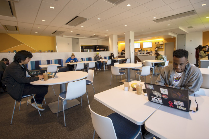 Students catch up on work and with each other in the new Café Roy.