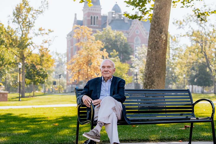 John Dittmer seated on bench in front of East College