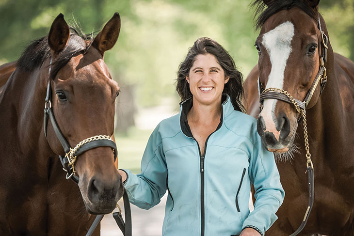 Nikki Dalesandro Scherrer ’07 with two horses