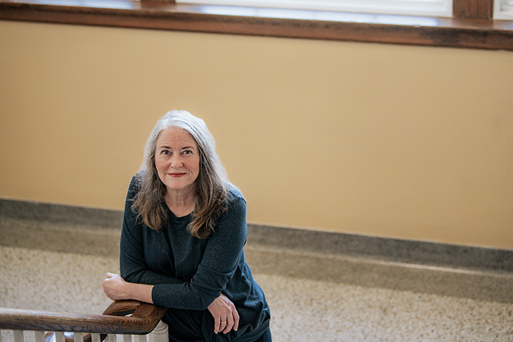 Professor Chris White standing on the Asbury Hall staircase